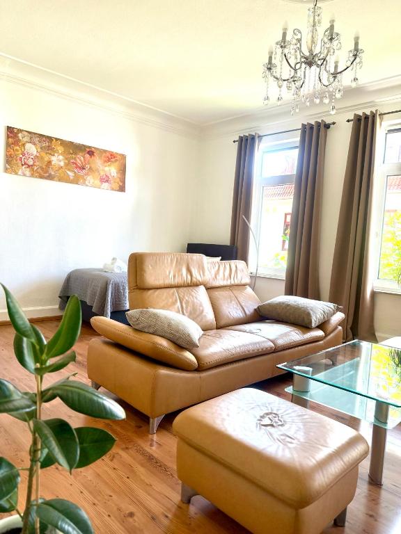 a living room with a couch and a glass table at Ferienwohnung Fleiger 2 in Achim Zentrum in Achim