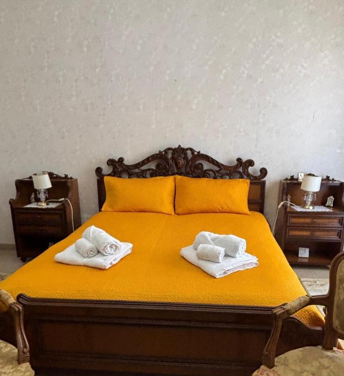 a bedroom with a bed with two towels on it at La CASA DEL SOLE in Paceco