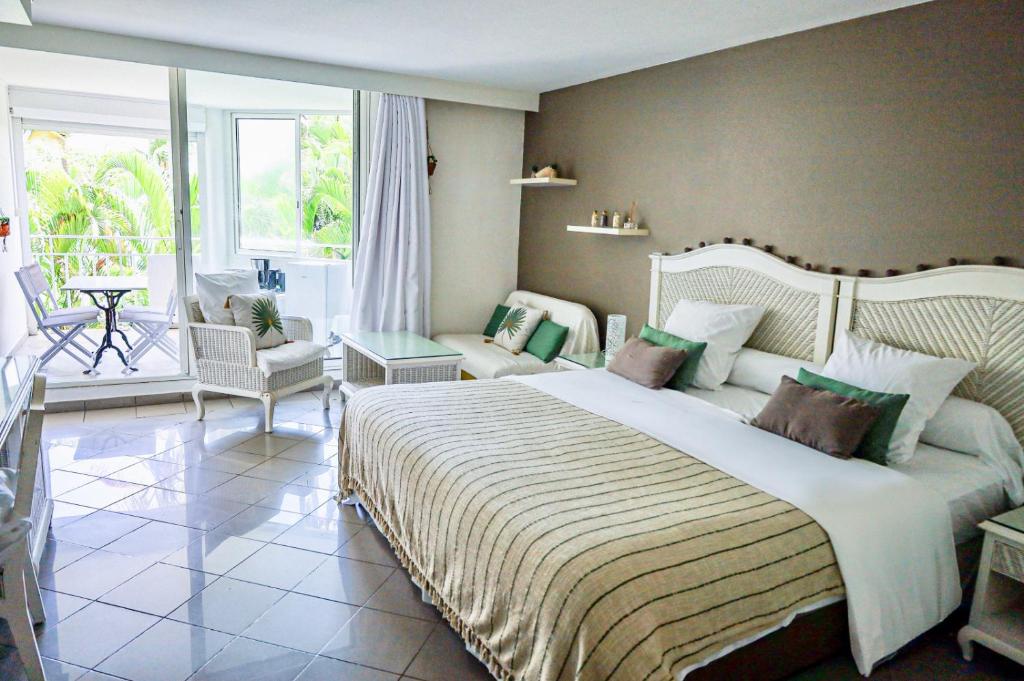 Ένα ή περισσότερα κρεβάτια σε δωμάτιο στο Front beach studio of ilet Gosier