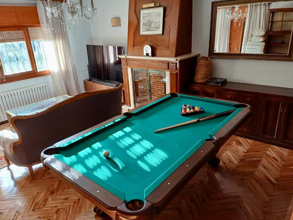 a pool table with two cuesticks on top of it at Quinta El Escorial in Escorial