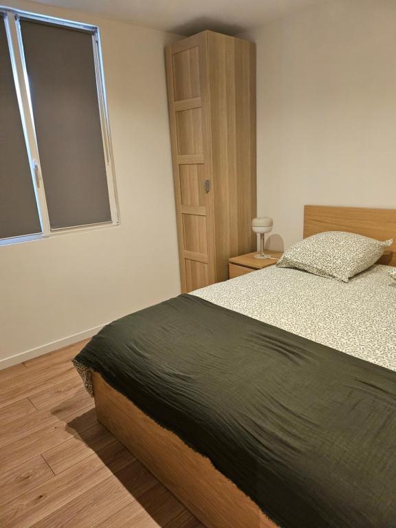 a bedroom with a large bed and a window at Grande Sologne in Clémont