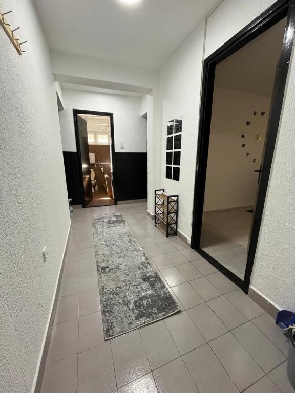 a hallway with a mirror and a rug on the floor at Apartman u srcu apatina in Apatin