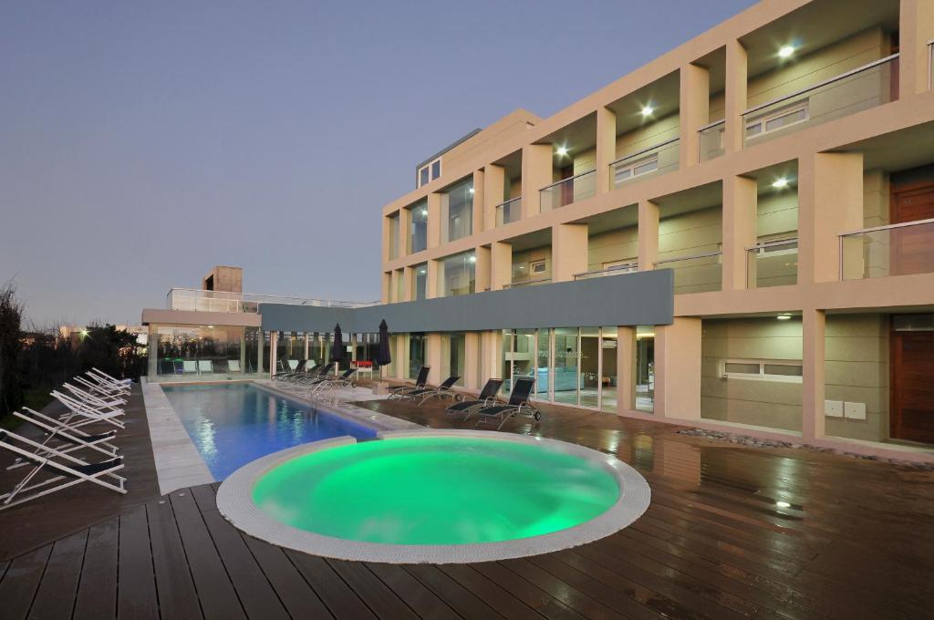a large building with a large pool in front of it at PROA Playa in Villa Gesell