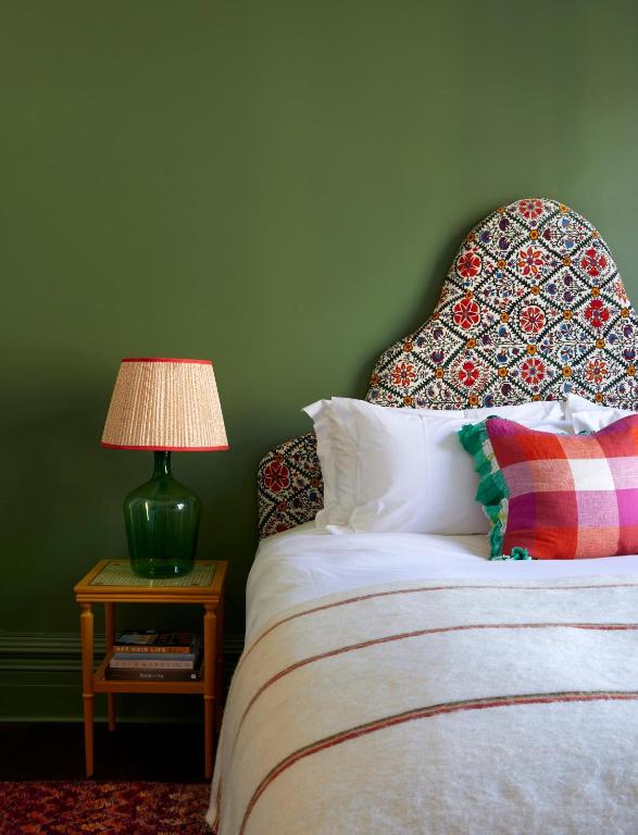 a bedroom with a bed with a lamp on a table at Artist Residence Brighton in Brighton & Hove