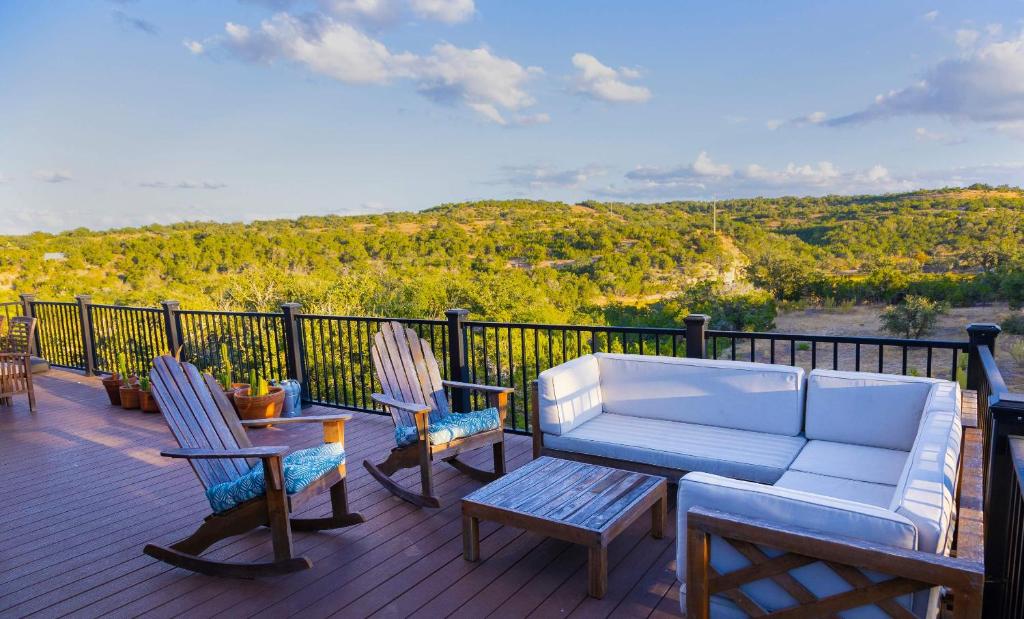 a couch and chairs on a deck with a view at Stargazers Delight - Sleeps 12 in Johnson City