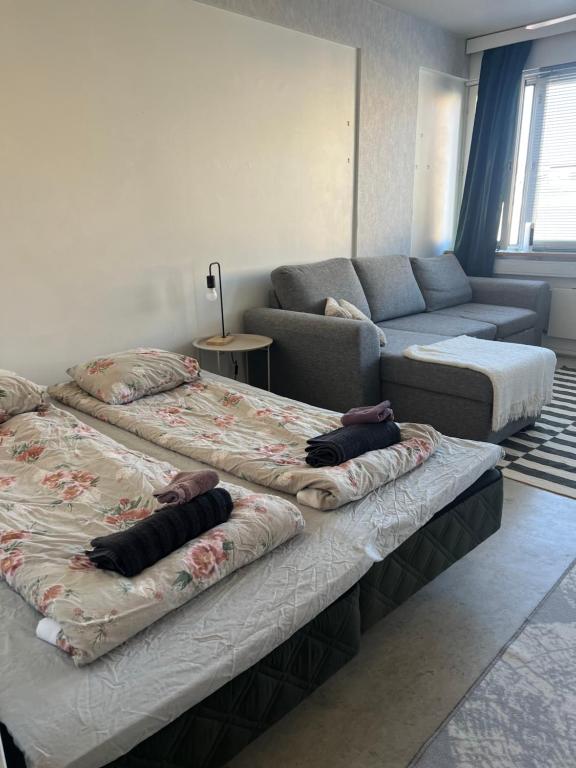 a living room with two beds and a couch at Apartment Kopin3 in Kokkola