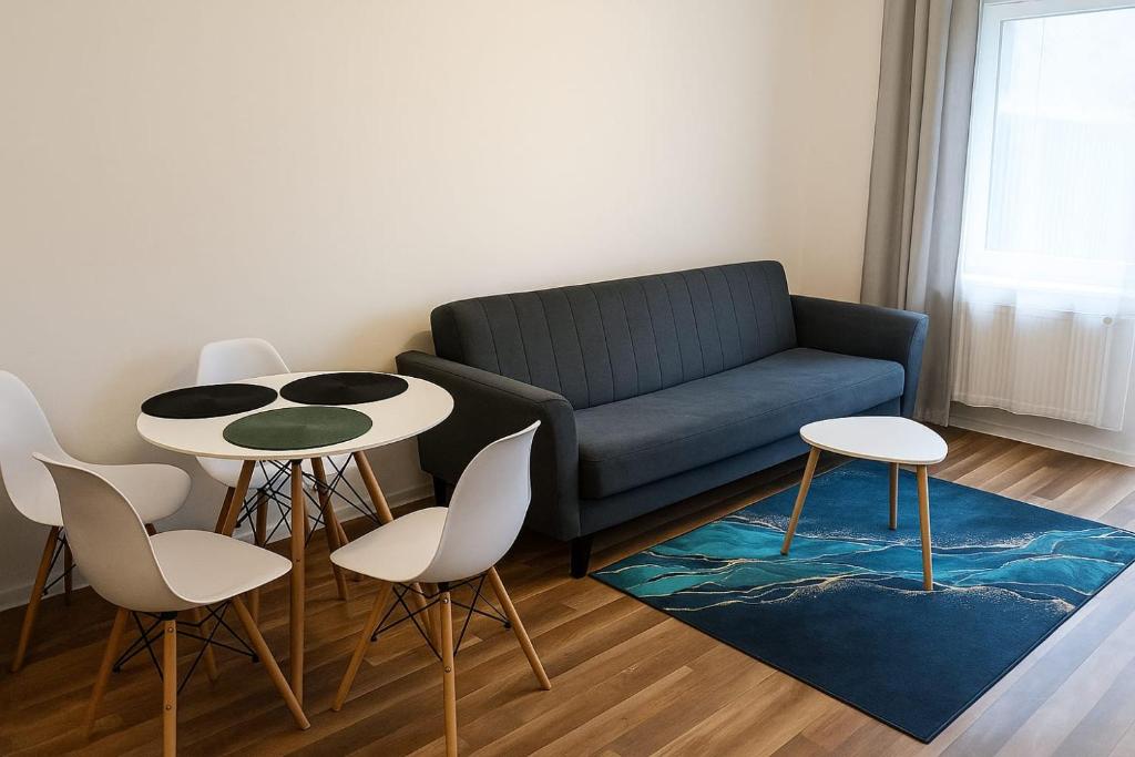 a living room with a couch and a table and chairs at Apartament Marzenie in Kowary