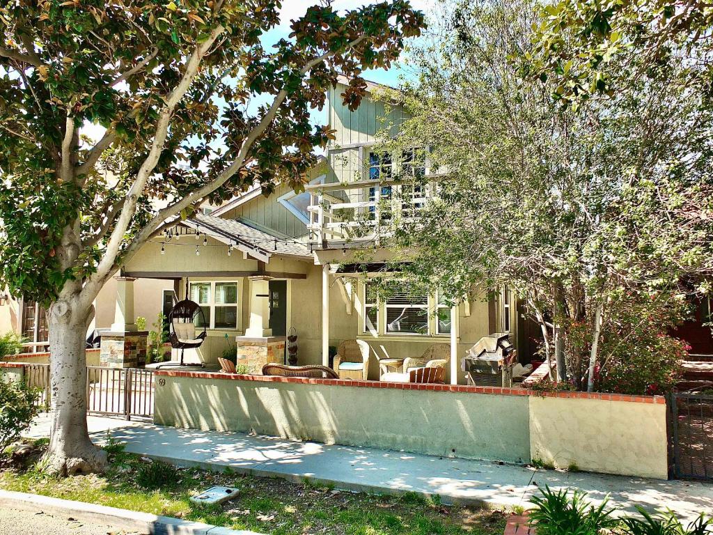 a house with a porch with chairs and trees at Park Avenue Beach Paradise - Chic & Secluded 4 BDR in Long Beach