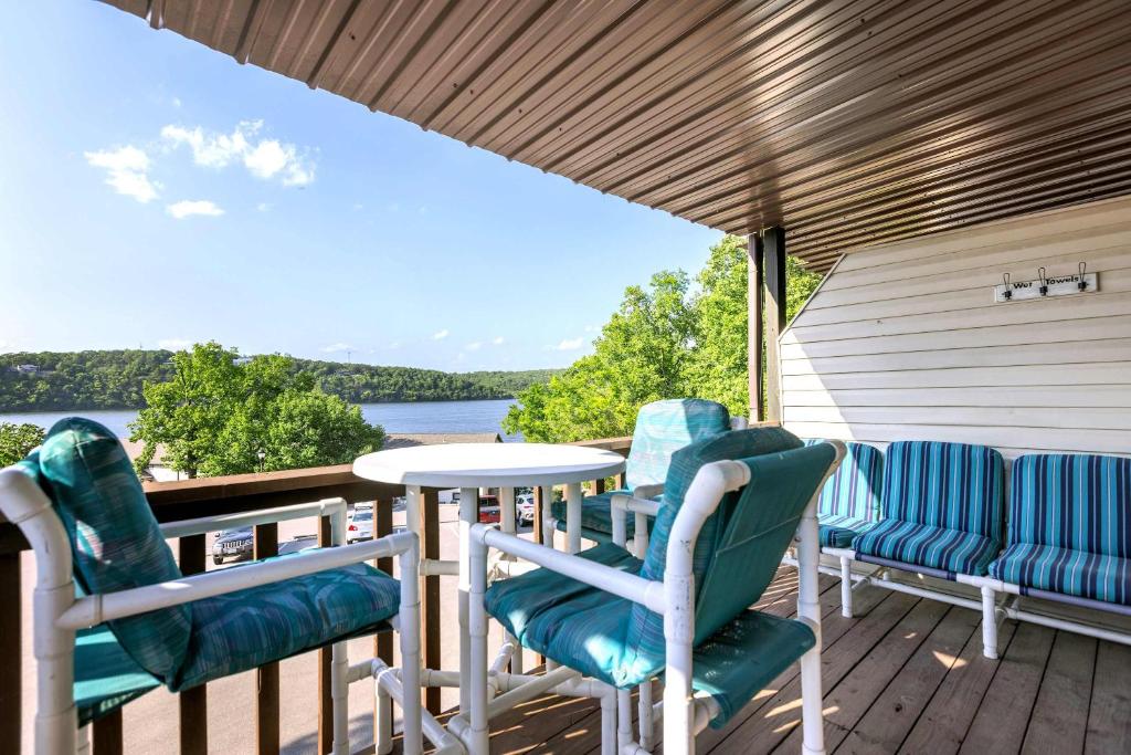 a porch with chairs and a table and a view of the water at The Nook at Weston Point - Cozy Condo Getaway in Osage Beach