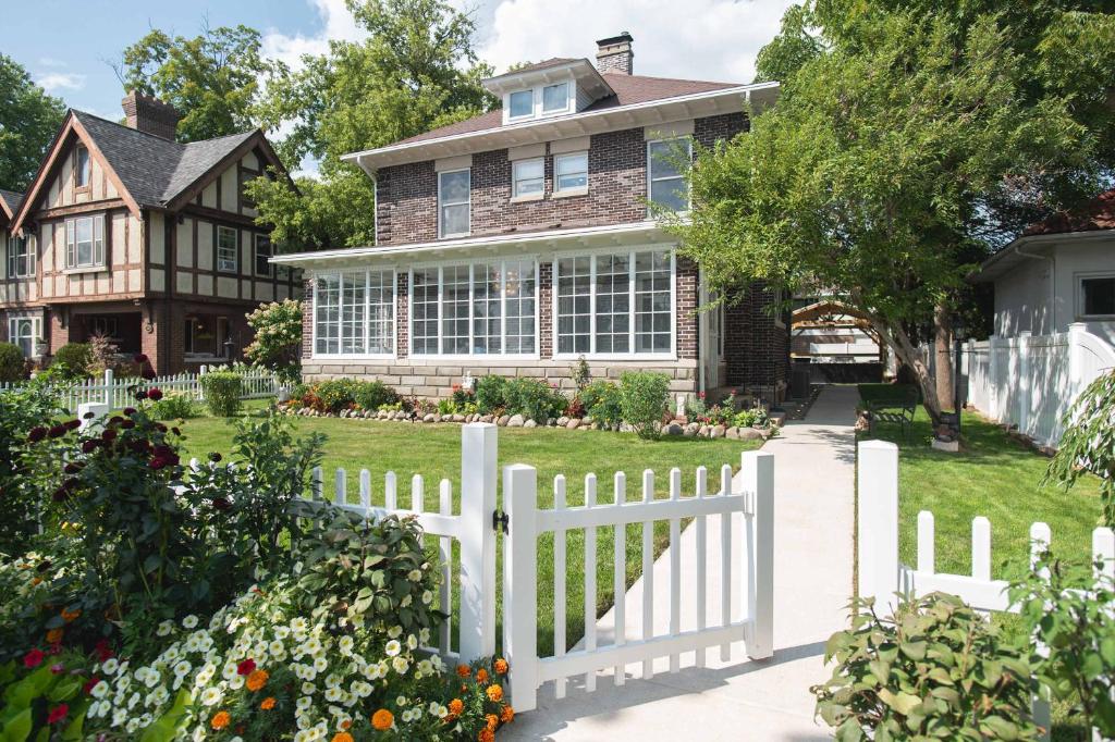 a white picket fence in front of a house at Its Showtime - Historic Downtown Geneva Escape in Lake Geneva