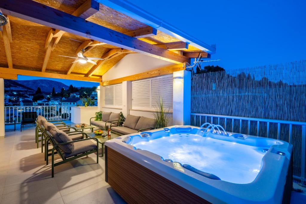 a hot tub on the balcony of a house at Villa Senka in Rogotin