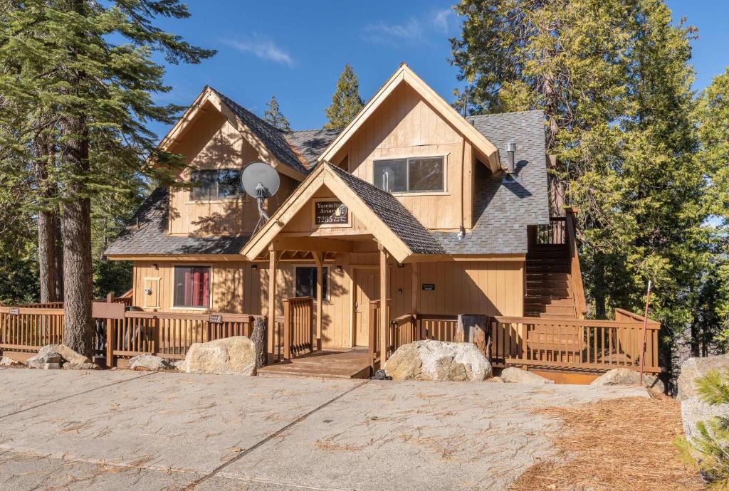 a house with a porch with a fence at Yosemite Quail - Nestled in with a View in Yosemite West