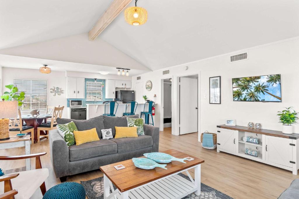 a living room with a couch and a table at Tranquil Turquoise - Pet Friendly in Port Aransas