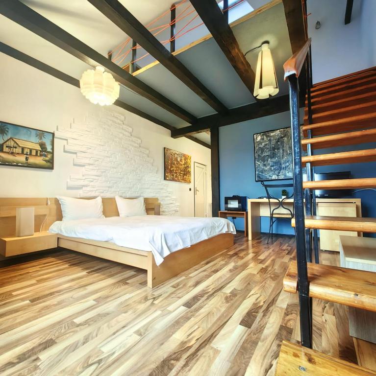 a bedroom with a bed and a staircase at Villa Santa Maria in Sibiu