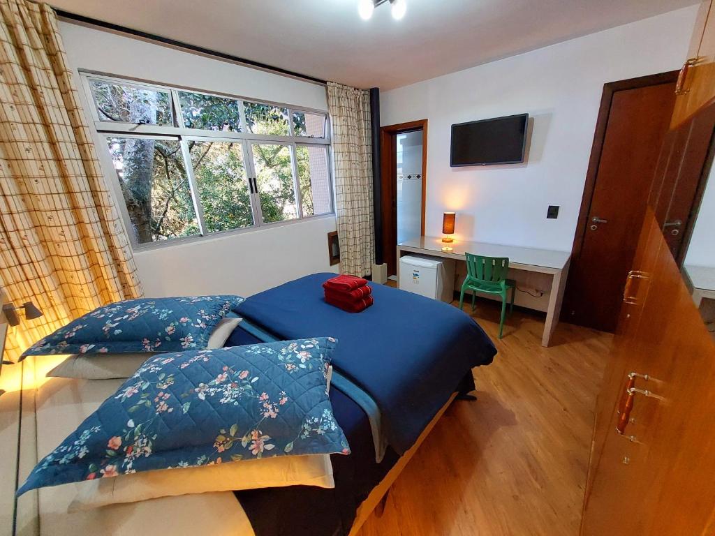 Ένα ή περισσότερα κρεβάτια σε δωμάτιο στο Pousada Casa Verde - Curitiba