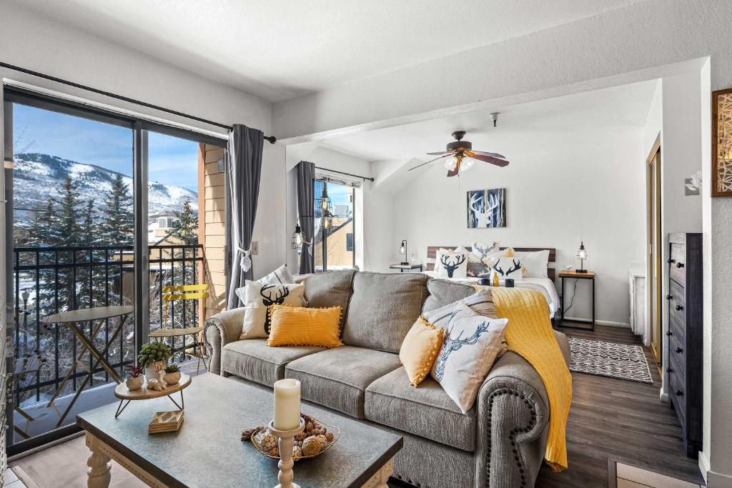 a living room with a couch and a balcony at Cozy PC Condo - Top Floor Studio in Park City