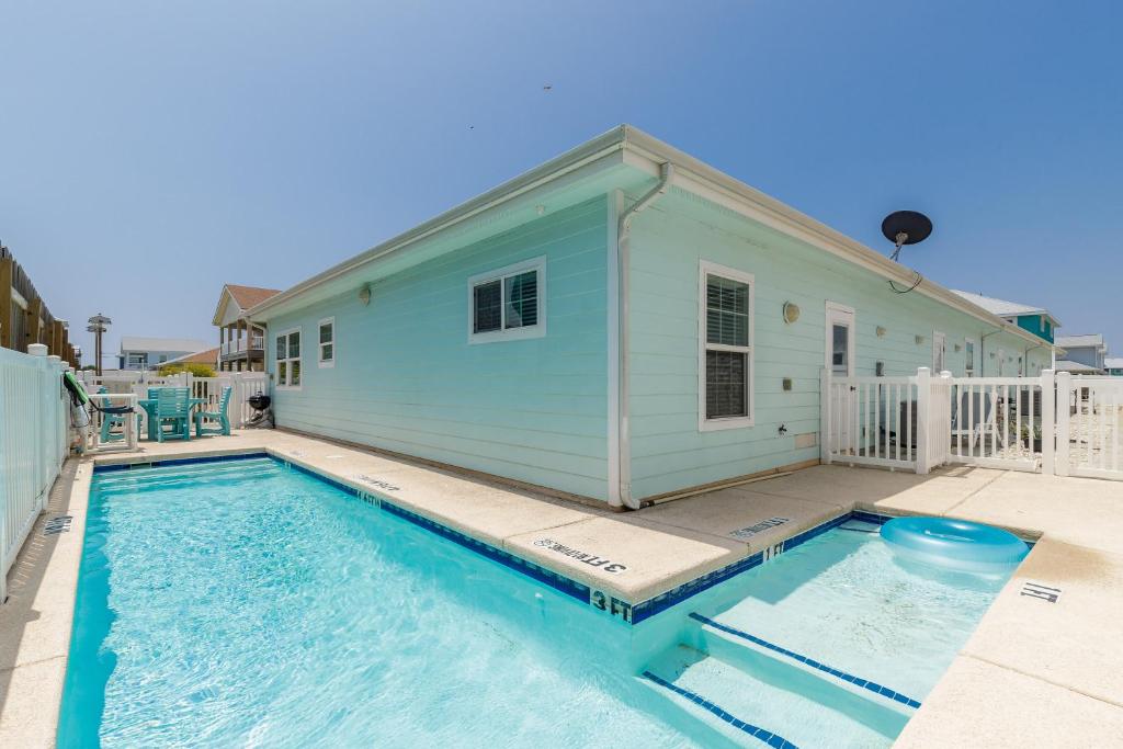 a swimming pool in front of a house at Fun 2 bedroom - Pets Pool Sleeps 6 in Port Aransas