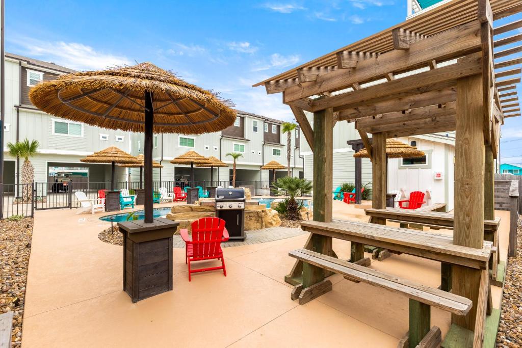 a patio with a table and an umbrella at Modern Comfort 3 Bedroom Pets in Port Aransas