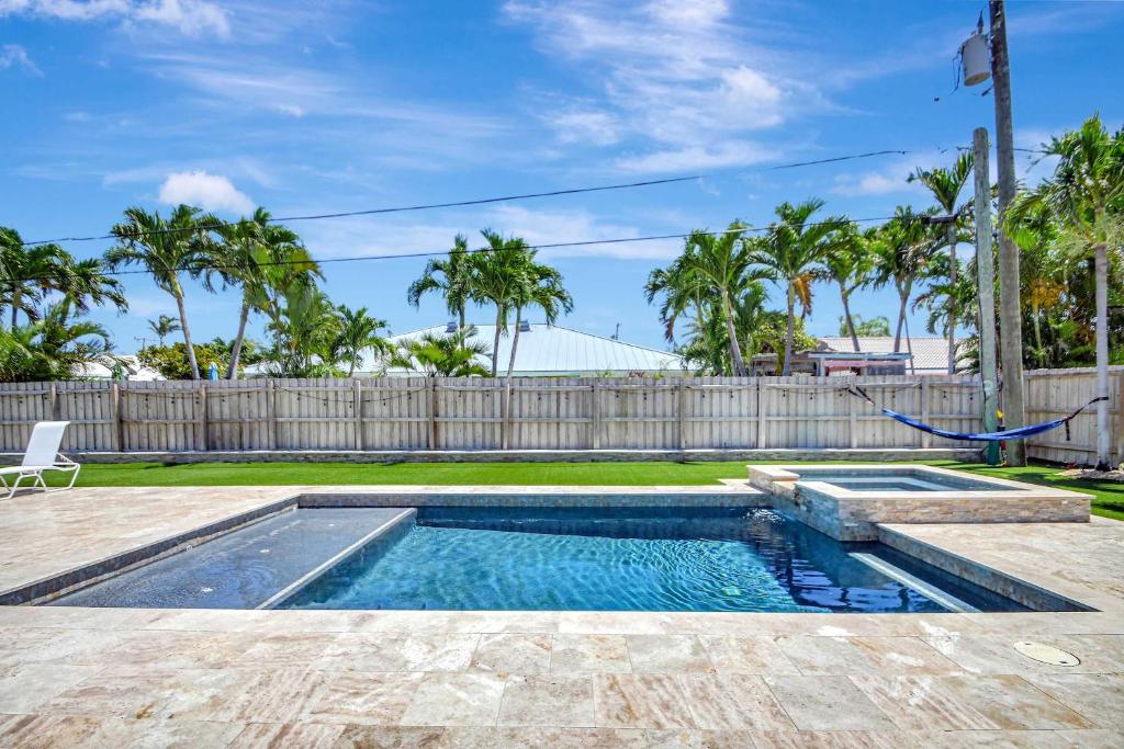 a swimming pool in a yard with a fence at Dolphin Villa - Private Pool in West Palm Beach