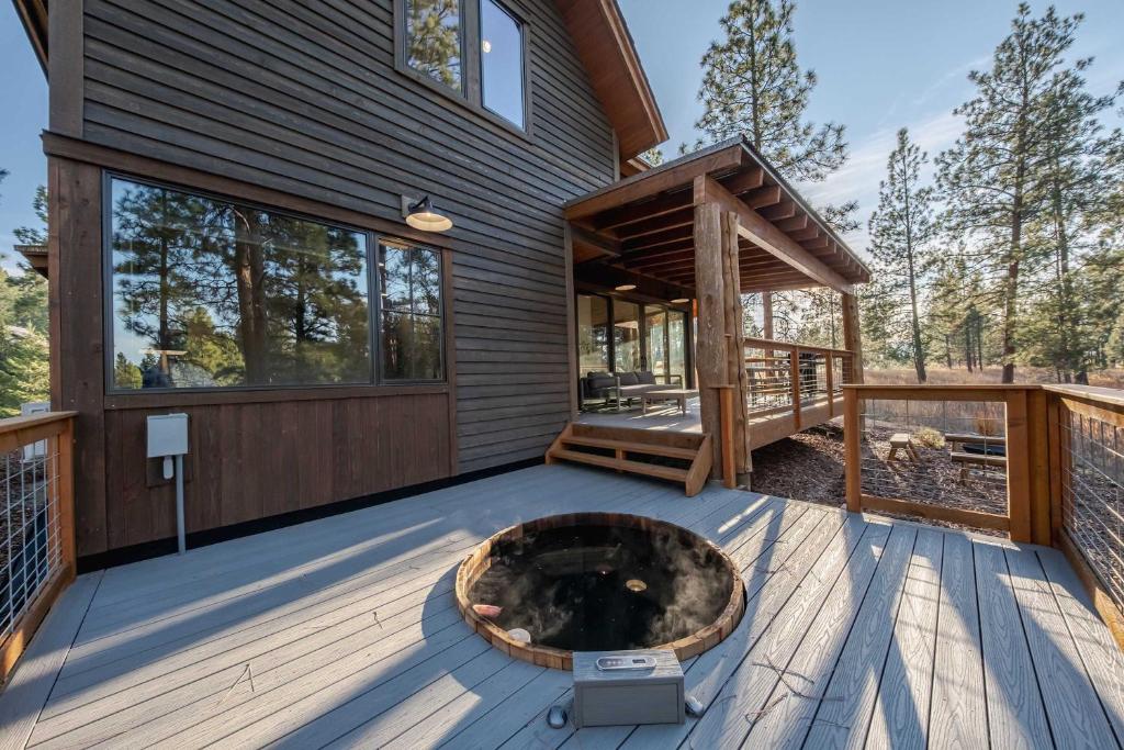 a deck with a fire pit on the side of a house at Wilderness Club Cabin - Sleeps 7 in Eureka