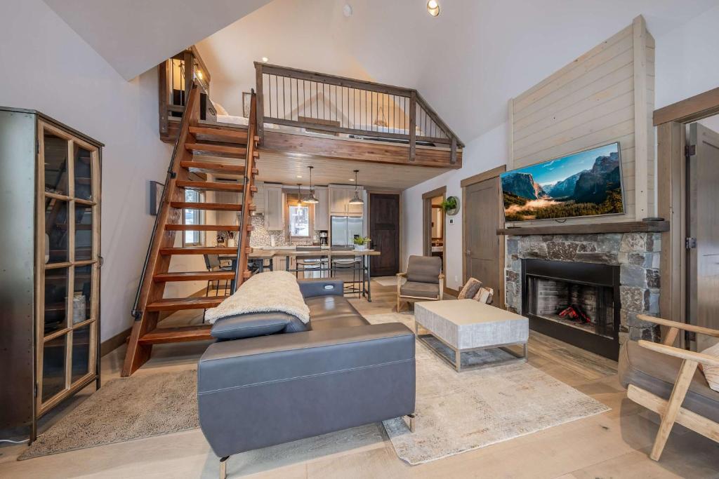 a living room with a couch and a fireplace at Wilderness Club Cottage on 18th Green in Eureka
