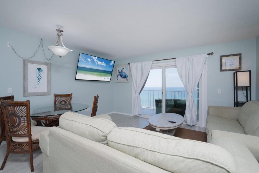 a living room with a white couch and a table at 1BR Sleeps 5 at The Summit with Ocean Front Views in Panama City Beach