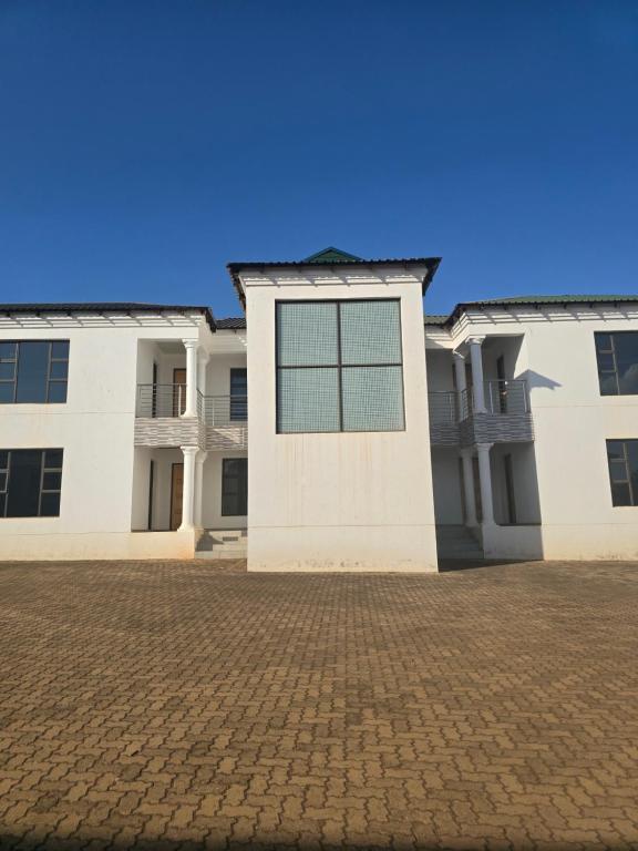 a white building with a window on the front at Lido System Makonde Village in Thohoyandou