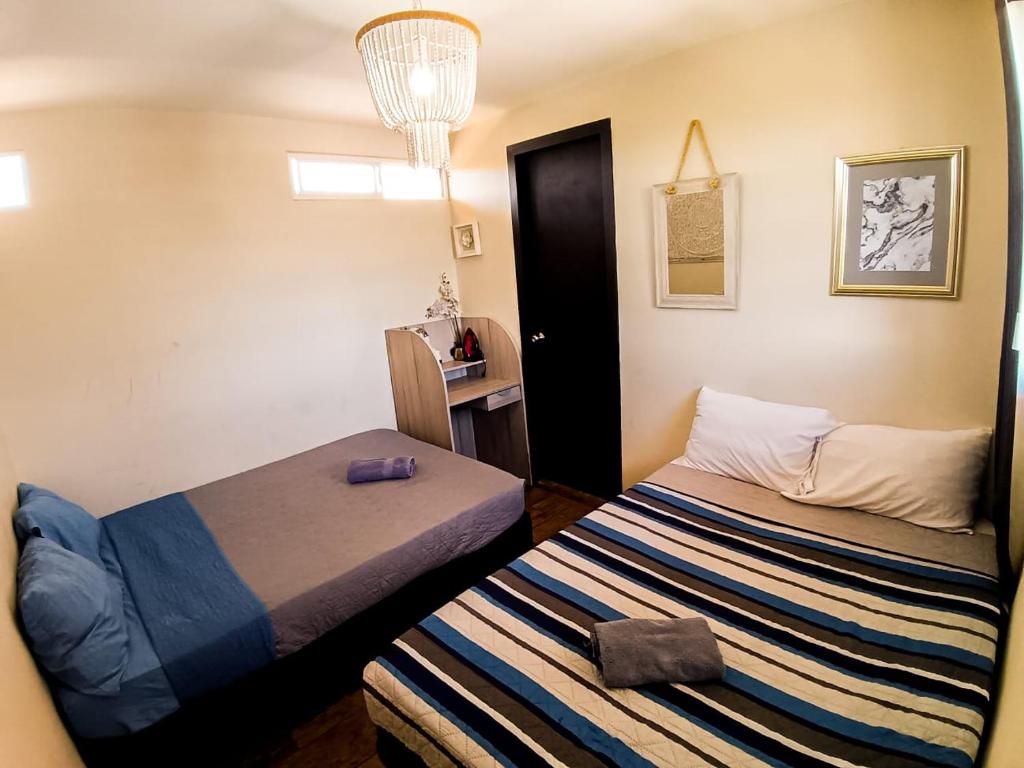 a small room with a bed and a small table at Dalia Room, Paseo Durango in Durango