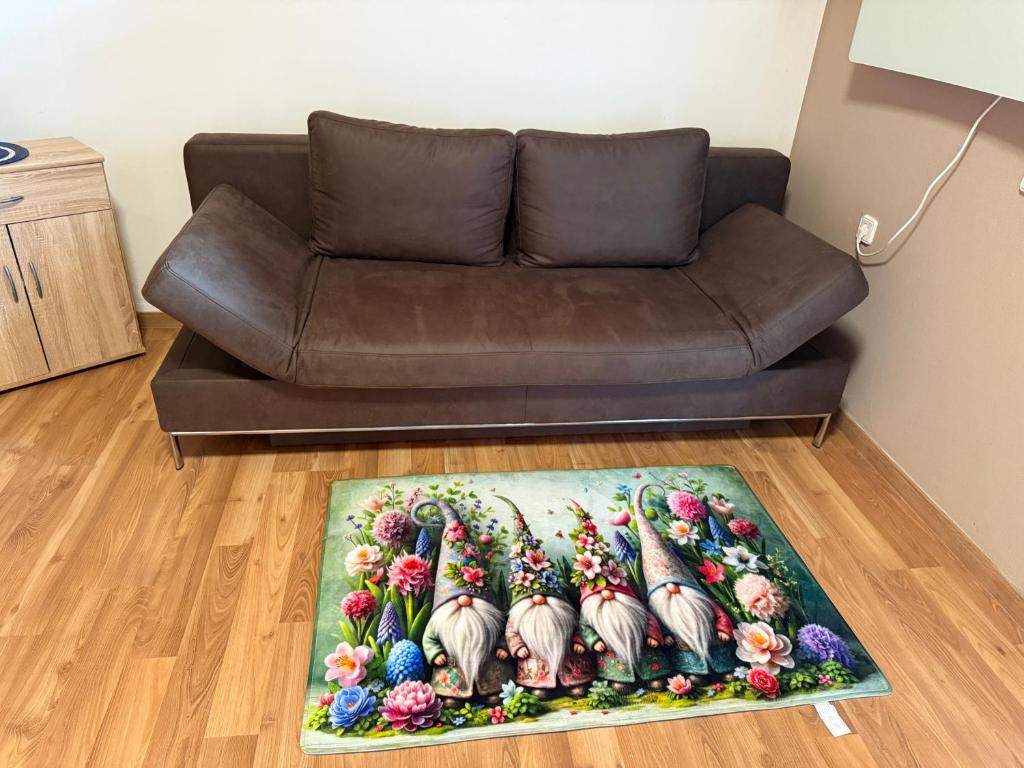 a brown couch in a living room with a rug at Gästehaus Elsa in Bad Rodach