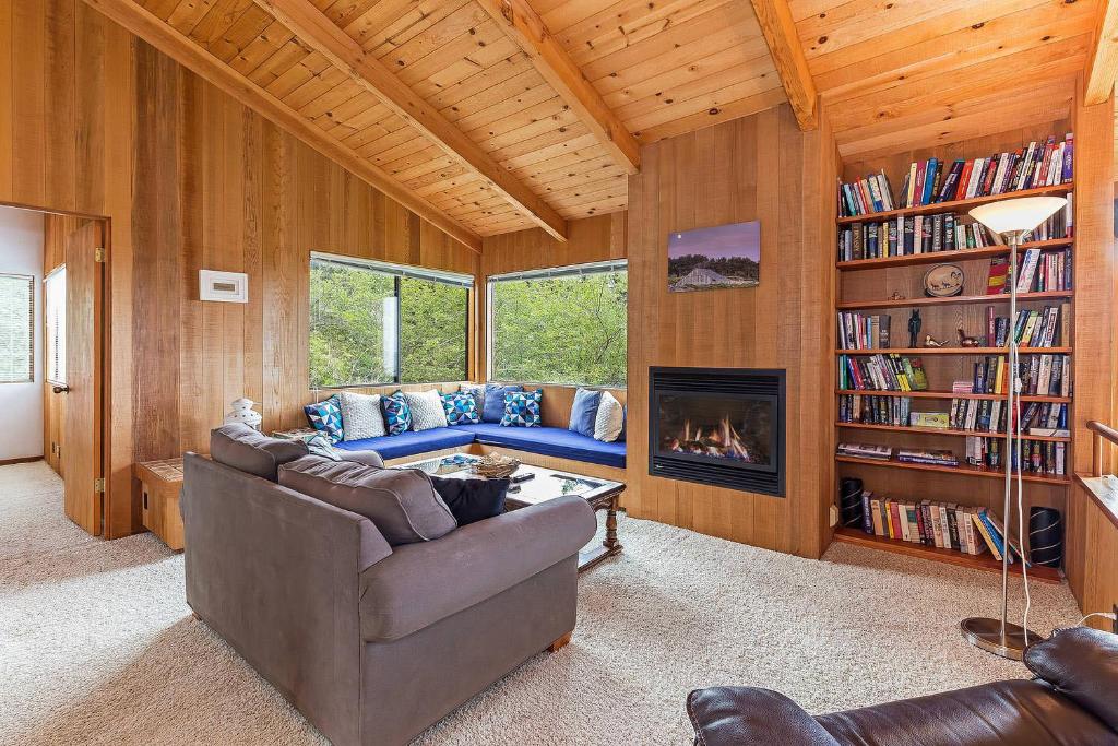 a living room with a couch and a fireplace at Seaclusion - Close to Trails - Hot Tub in Sea Ranch