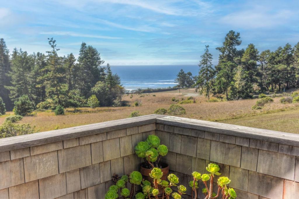 a retaining wall with a view of the ocean at Architectural Treasure - Private Hot Tub in Sea Ranch