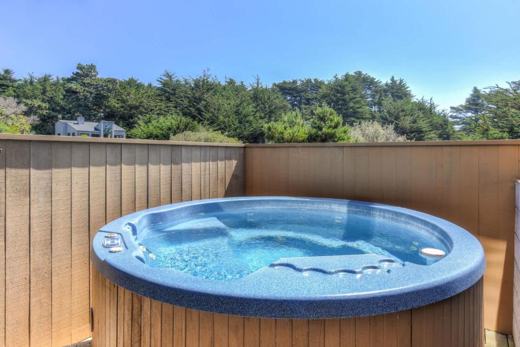 a hot tub sitting on a fence at Sea Meadow - Panoramic Ocean View in Sea Ranch