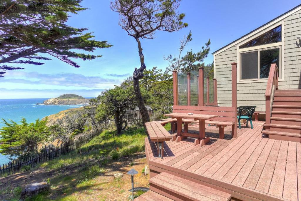 a wooden deck with a bench and the ocean at Haven's View With Stunning Ocean Views in Gualala