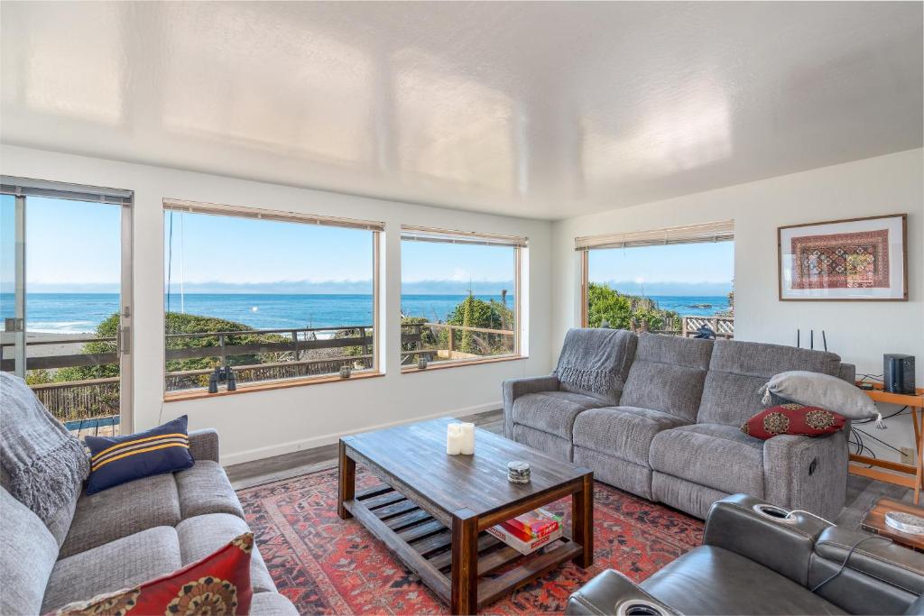 a living room with a couch and a table at Ocean Bungalow - Tesla EV Station & Near Trails in Gualala