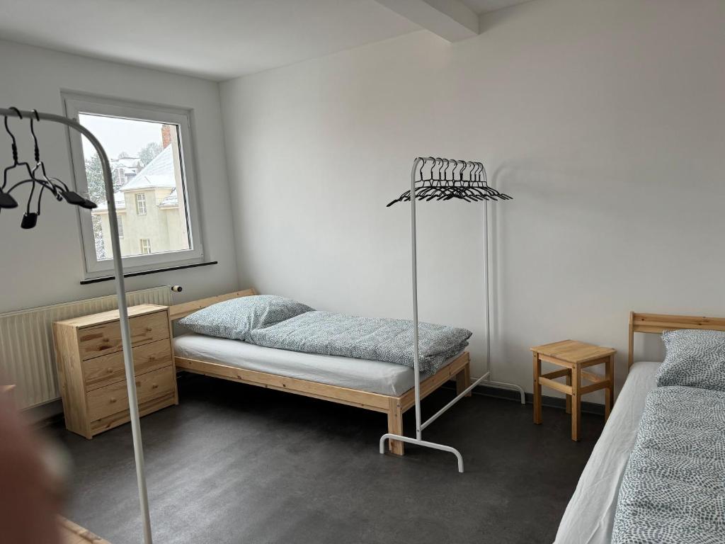 a bedroom with a bed and a room with a lamp at Monteur Budget-Ferienhaus in Hof, stadtnähe in Hof
