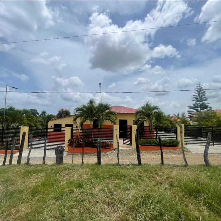 a house with a fence in front of it at Rancho La Loma in Higuey