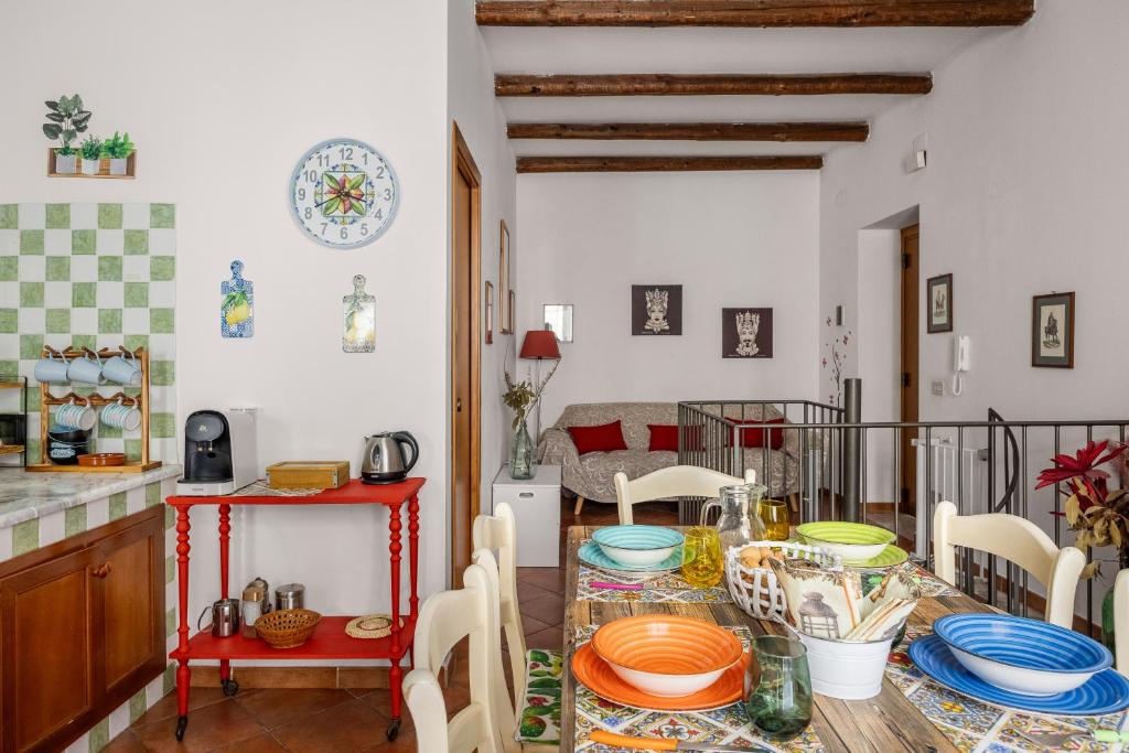 a kitchen with a table with plates on it at Palermo - centro storico in Palermo