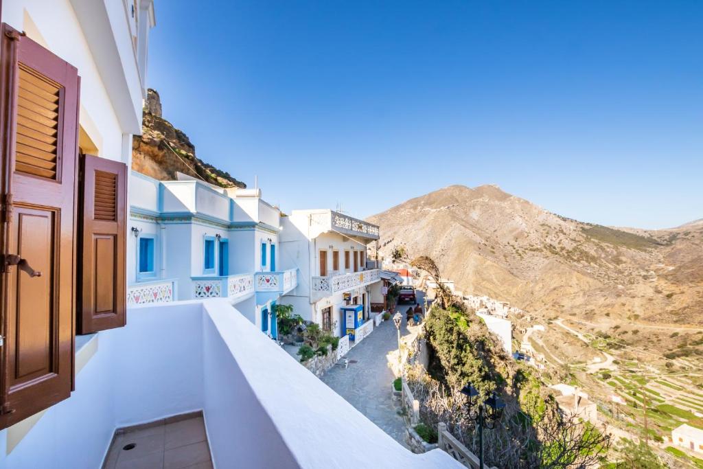 a view from the balcony of a house with blue and white buildings at Sofia Mike Houses in Olympos