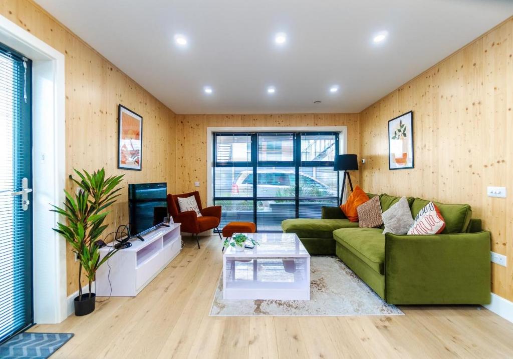 a living room with a green couch and a table at Green Mews 3 with Free Parking - By My Getaways in Brighton & Hove