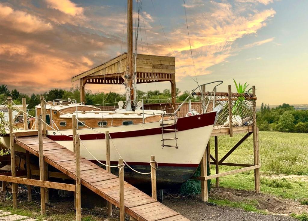 a boat parked next to a wooden dock at Asila's Ark in Keyworth