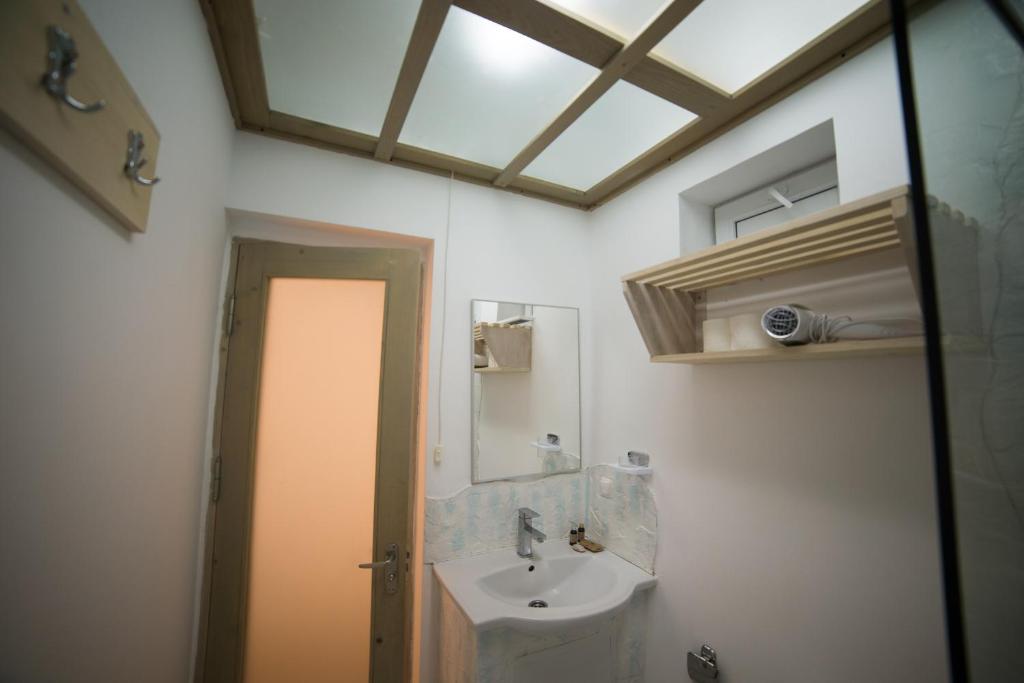 a bathroom with a sink and a mirror at Oneiro Resort in Mamaia Nord