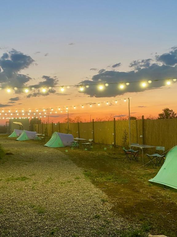 a group of tents in a yard at sunset at Sea Side Camping in Vama Veche