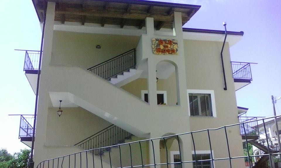 a building with a staircase on the side of it at B&B Da Rosa Camerota in Camerota