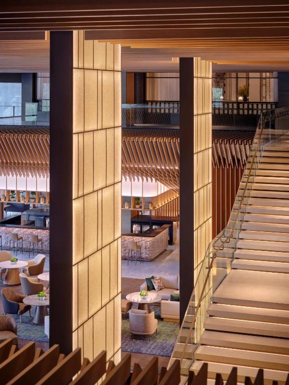 A dramatic staircase overlooking the hotel's layered lounge areas.