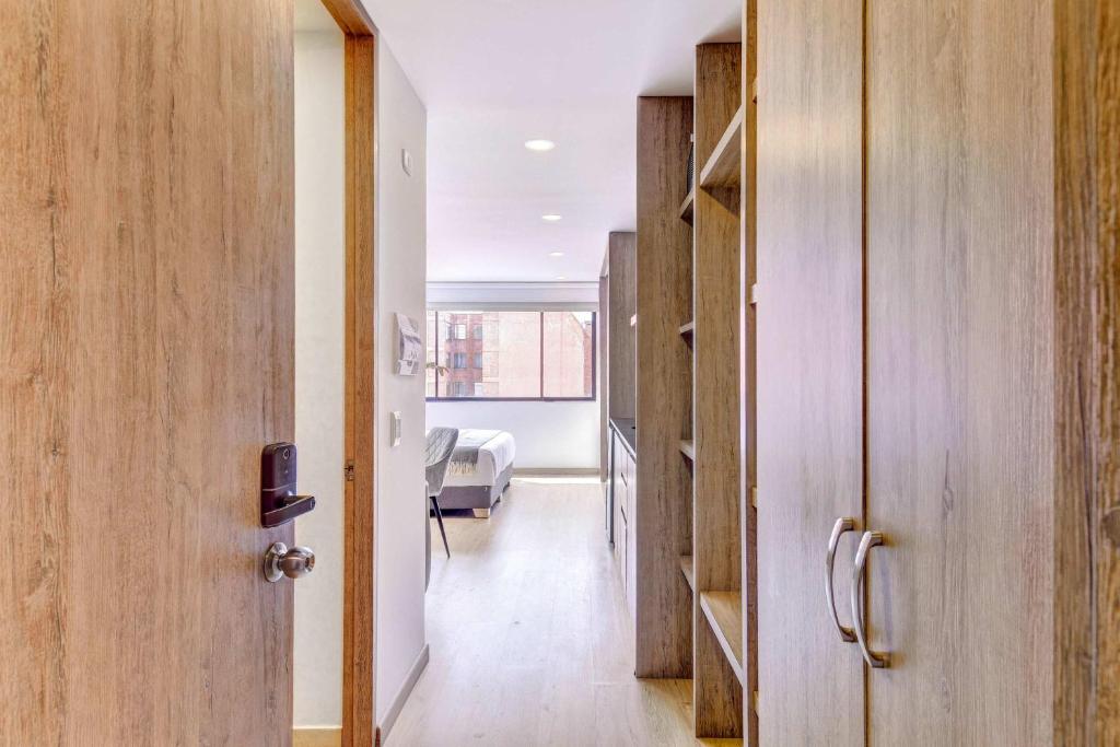 a hallway with a door and a room with a bed at Premium Loft in Bogota in Bogotá