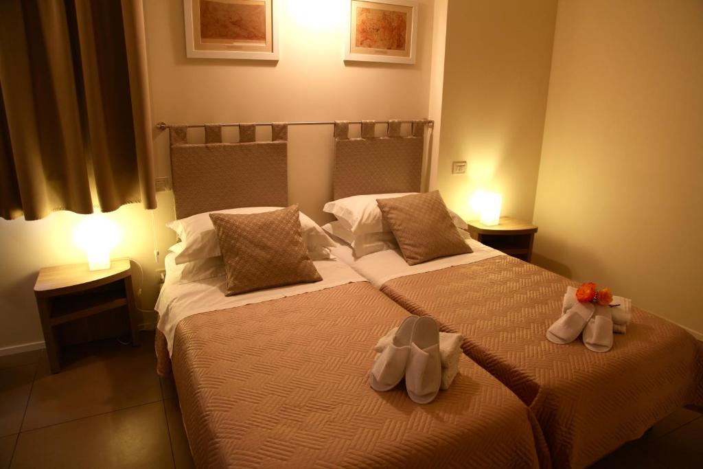 Postel nebo postele na pokoji v ubytování Palazzo Ruschioni Boutique Hotel