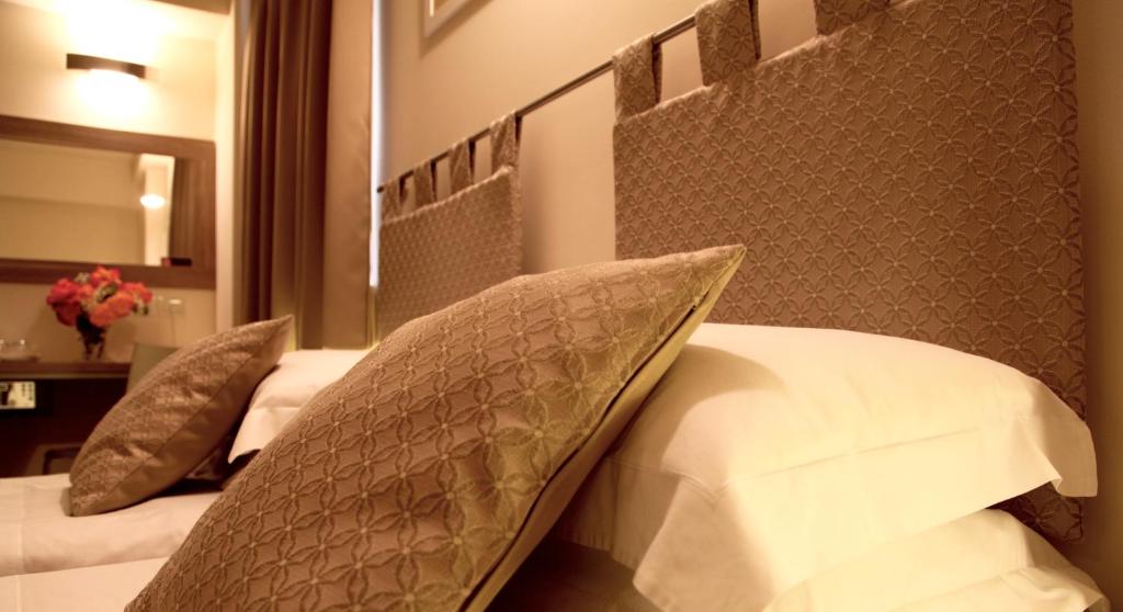 Postel nebo postele na pokoji v ubytování Palazzo Ruschioni Boutique Hotel
