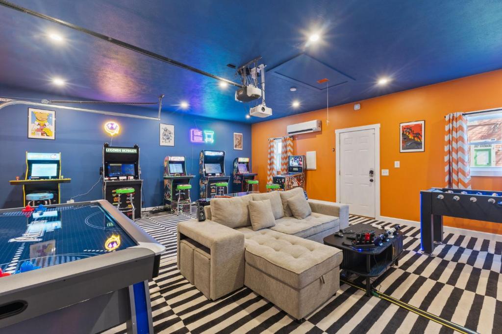 a living room with a couch and a pool table at Stay & Play Indy- Indoor Fun - 5 Min to Downtown - Sleeps 10 - Arcade fun in Indianapolis