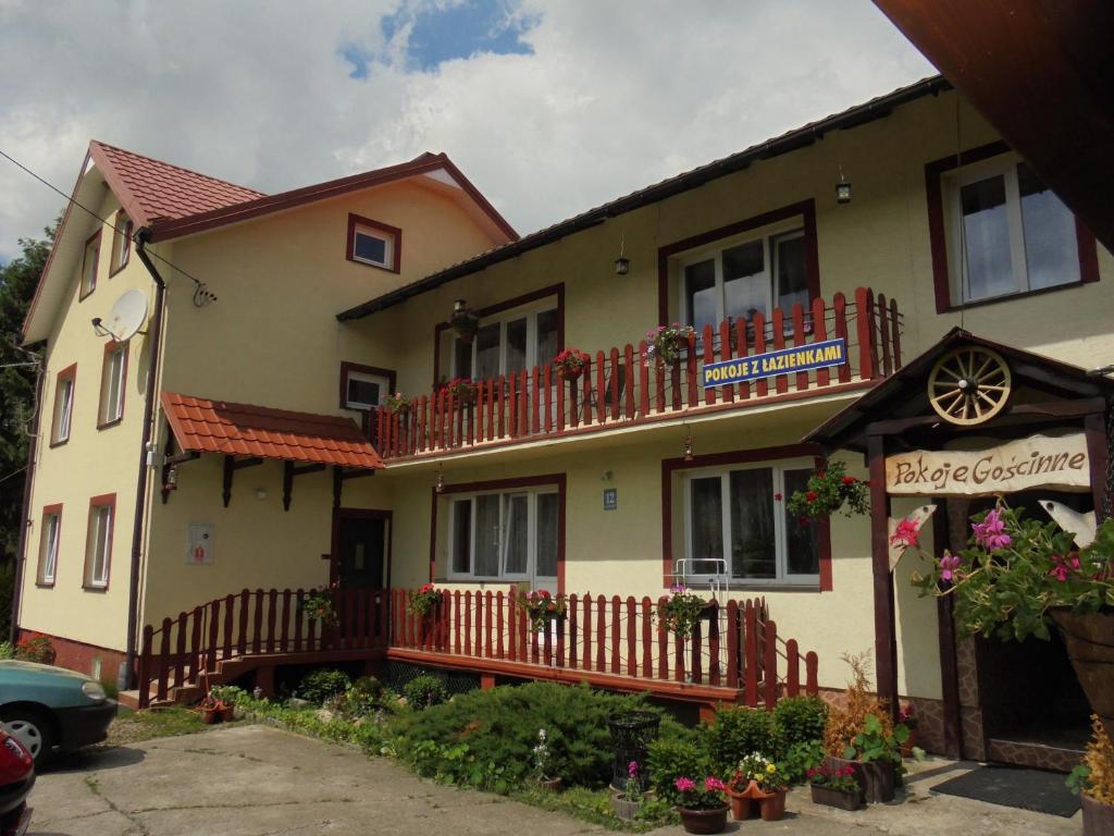 a house with red balconies on the side of it at Jasionka in Ustrzyki Dolne