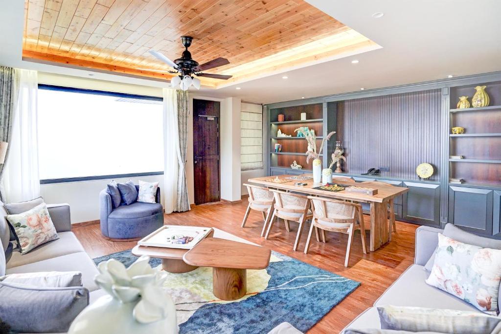 a living room with a couch and a table at Sunday Premium 5 BHK Villa Mihika, Shimla in Shimla